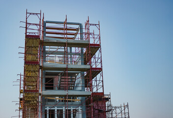 Building with scaffolding against the blue sky. Renovation concept. Superbonus 110 in Italy.