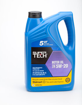 Ellington, CT, USA - December 10 2011 - Five quart container of Walmart brand 5W-20 moror oil with a black oil filter.