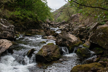 Fast flowing water/waterfalls flowing through the Aberglaslyn Pass near to Beddgelert, in Snowdonia National Park, north Wales