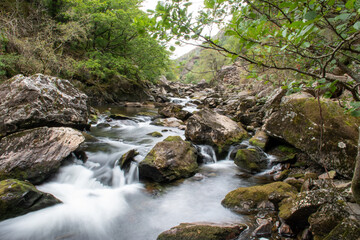 Fast flowing water/waterfalls flowing through the Aberglaslyn Pass near to Beddgelert, in Snowdonia National Park, north Wales
