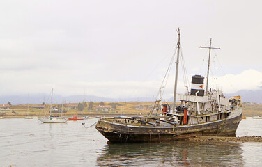 Fototapeta premium The Historic St. Christopher Shipwreck at the dock area of Ushuaia's Coast, Province of Tierra del Fuego, Argentina