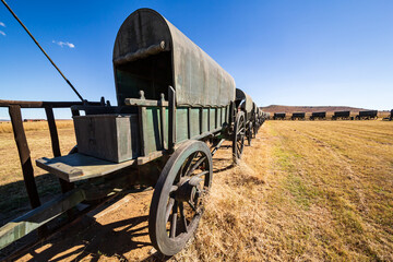 Circle of 64 replica Voortrekker wagons cast in bronze at Blood River Heritage Site, KwaZulu-Natal,...