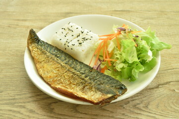 grilled saba fish or mackerel with rice topping sesame and salad on plate