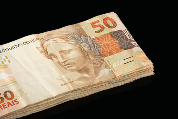 Brazilian money. 50 reais banknotes. Brazilian finance concept. Black background