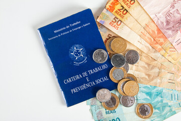 Brazilian document work and social security (Carteira de Trabalho e Previdencia Social) with Brazilian money banknotes