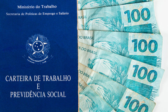 Brazilian document work and social security (Carteira de Trabalho e Previdencia Social) with Brazilian money banknotes