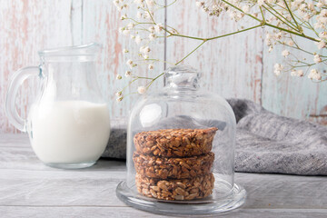 Baked cookies and a decanter of fresh milk milk. Rye spikelets, bread preparation