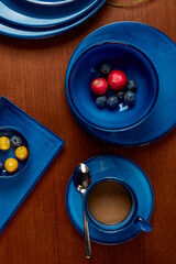 Coffee and fruit in blue cutlery
