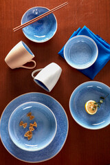 Blue cutlery with raw bow noodles and lemon