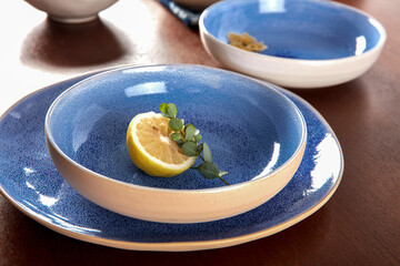 Blue cutlery with raw bow noodles and lemon