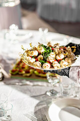 waiter holds plate with food. Restaurant service. buffet or catering.