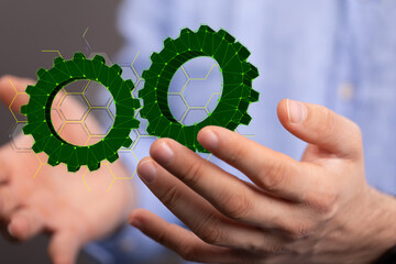 Mechanism, green metallic gears and cogs at work on brown background. Industrial machinery. 3D