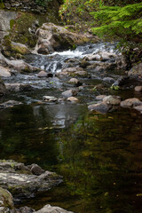 Naklejka na ściany i meble Long exposure photography of rocks in rapids/waterfalls of River Llugwy at Betws-y-Coed, Snowdonia, Wales