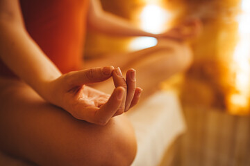 Women in meditation while practicing yoga in a salt room. Happy, calm and relaxing. Side view of...