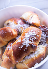 sweet buns with powdered sugar plate close-up