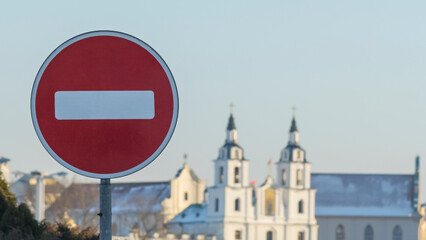 No Entry road sign on old orthodox church background. Winter. The road is closed red round sign.
