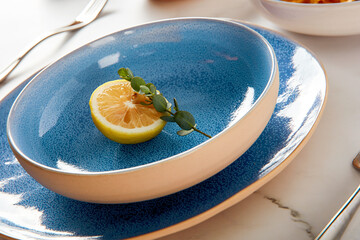 Blue cutlery with raw bow noodles and lemon