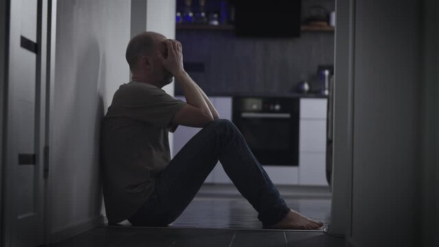 A man in a deep depression due to a midlife crisis. Sadness and melancholy piled up in the form of emotional problems