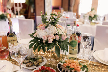banquet table in a restaurant on a holiday with food and drinks