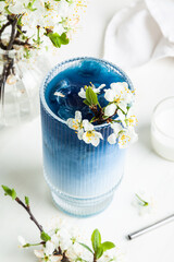 Blue matcha latte in a glass.