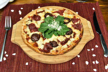 pizza is a dish of Italian origin consisting of a usually round, flat base of leavened wheat-based dough topped with tomatoes, cheese, and often various other ingredients, which is then baked at a hig