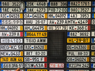 Wall of old European license plates