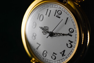 Naklejka na ściany i meble Close up of an old worn gold pocket watch. Vintage retro watch. Dark background.