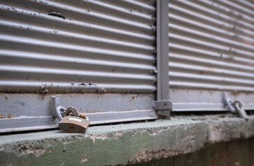Closed shop shutter and padlock. Economic crises and bankruptcies