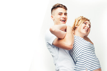 young pretty teenage couple, hipster guy with his girlfriend happy smiling and hugging isolated on...