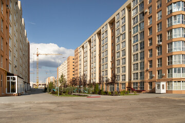 Fototapeta na wymiar Residential multi-storey residential complex with park yard in the middle