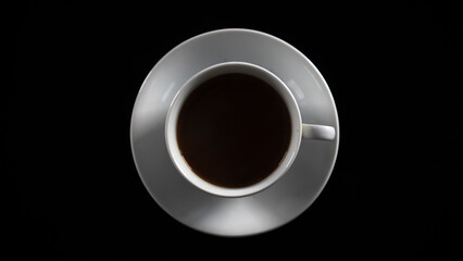 Filter coffee in white cup and coaster, isolated on black background, top view