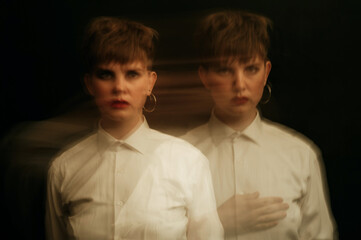 crazy psychopathic girl with mental disorders in a straitjacket on a dark background