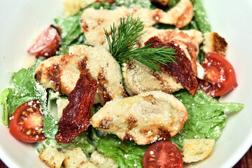 A salad is a dish consisting of mixed, mostly natural ingredients with at least one raw ingredient. 