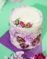 Soy candle handmade with flowers. Beautiful handmade candle. Relaxation atmosphere. Luxurious lifestyle.