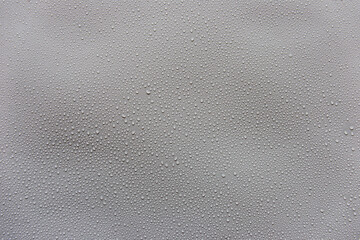 Water droplets on gray background covered with water droplets, bubbles in water.