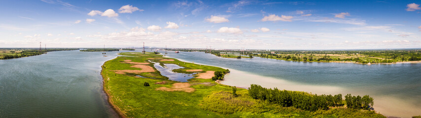 Fototapeta na wymiar Panoramic aerial view of Varennes islands and the St. Lawrence Seaway with Montreal in background.