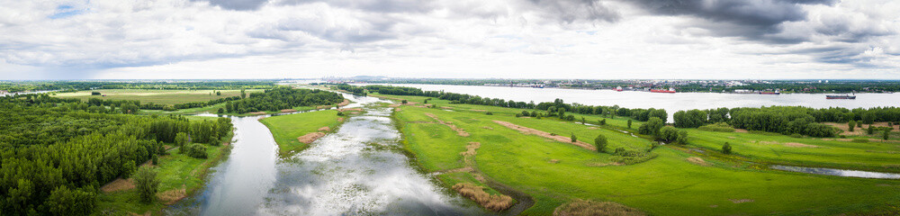 Fototapeta na wymiar Panoramic aerial view of Boucherville islands and the St. Lawrence Seaway with Montreal in background.