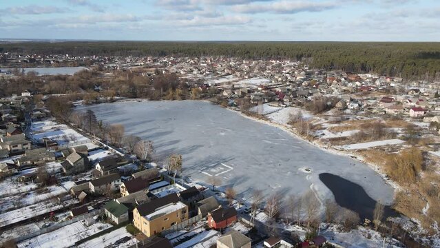 Horenka village before the war in Ukraine, winter time. Frozen lake, snow on the top of house. Village near Irpen, Bucha, Gostomel before war.