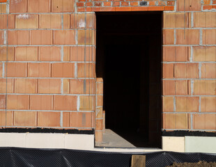 Single-family home made of hollow blocks or bricks. New unfinished stand-alone house building under construction.