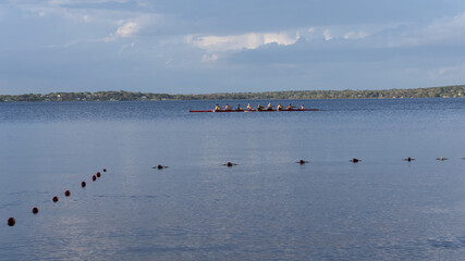 Clermont, FL USA 3-9-2022: Rowing team chugging across Lake Minneola on the Clermont chain of lakes.