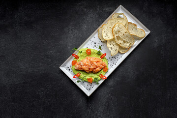 Salmon tartar with red caviar and croutons