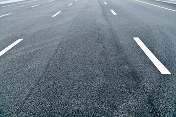 Asphalt road with white dashed lines