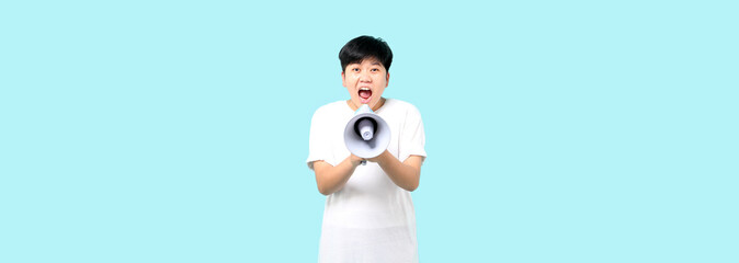 tomboy Asian over isolated blue background shouting through a megaphone in studio With copy space. - obrazy, fototapety, plakaty