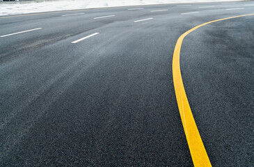 Fototapeta na wymiar Asphalt road with white stripes and yellow lines