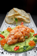 Salmon tartar with red caviar and croutons