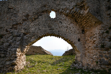 Fototapeta na wymiar A stone arch in the ruins of the medieval castle of Gioia Sannitica in the province of Caserta, Italy.