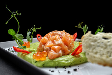 Salmon tartar with red caviar and croutons