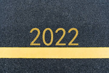 Number 2022 and yellow line on asphalt road