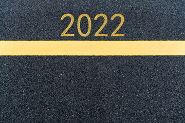 Number 2022 and yellow line on asphalt road