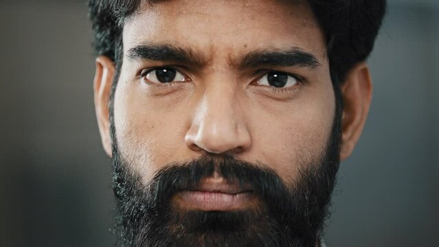 Close-up portrait of angry arabian business man worker male upset bearded latino face looking confident at camera serious brutal eyesight showing despair unhappy emotion disappointed facial expression